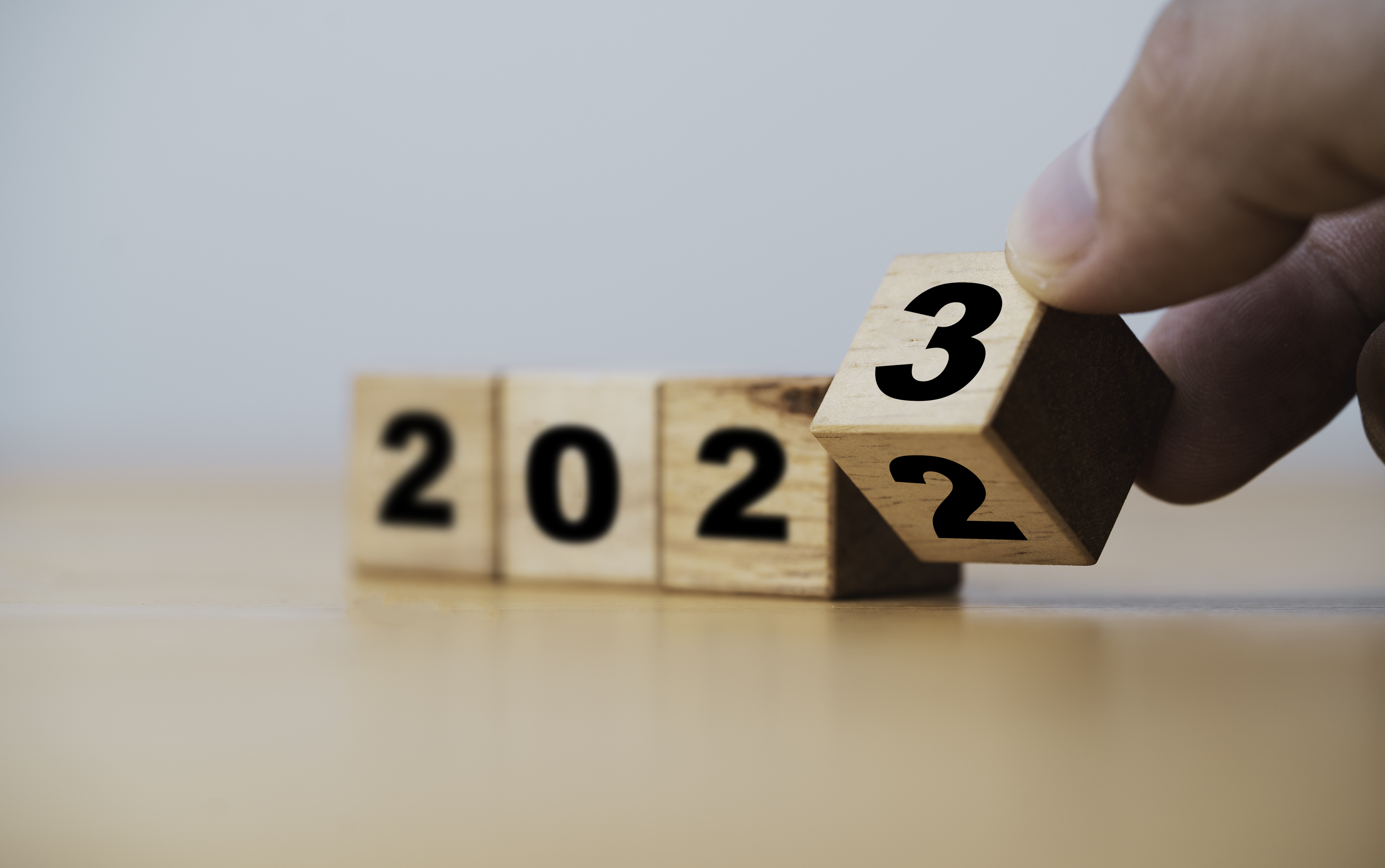 Wooden toy blocks that show 2022 turning to 2023.