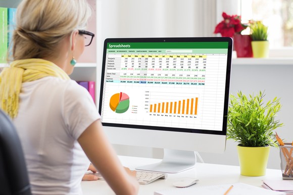 A businessperson works in a spreadsheet.