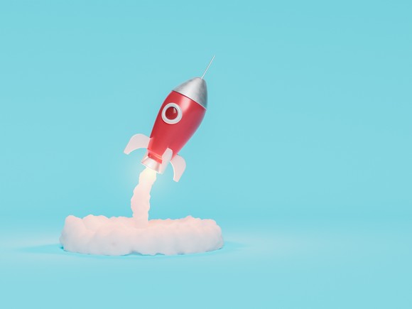 A play rocket taking off on a light blue background.