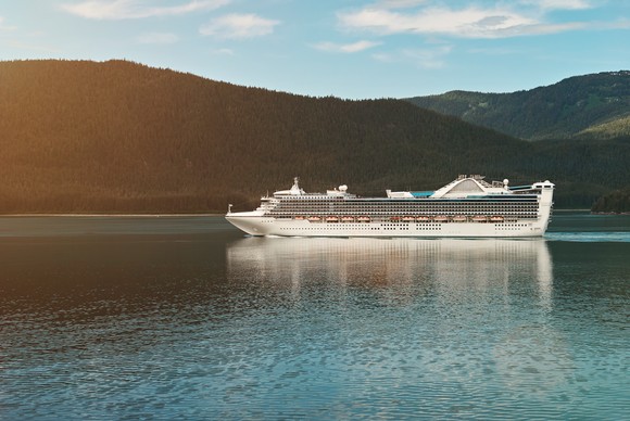 A cruise ship with hills in the background.