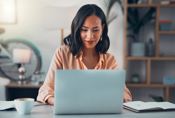 A businessperson works on a laptop.