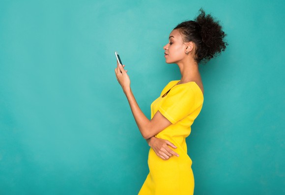 A person looks at a smartphone.