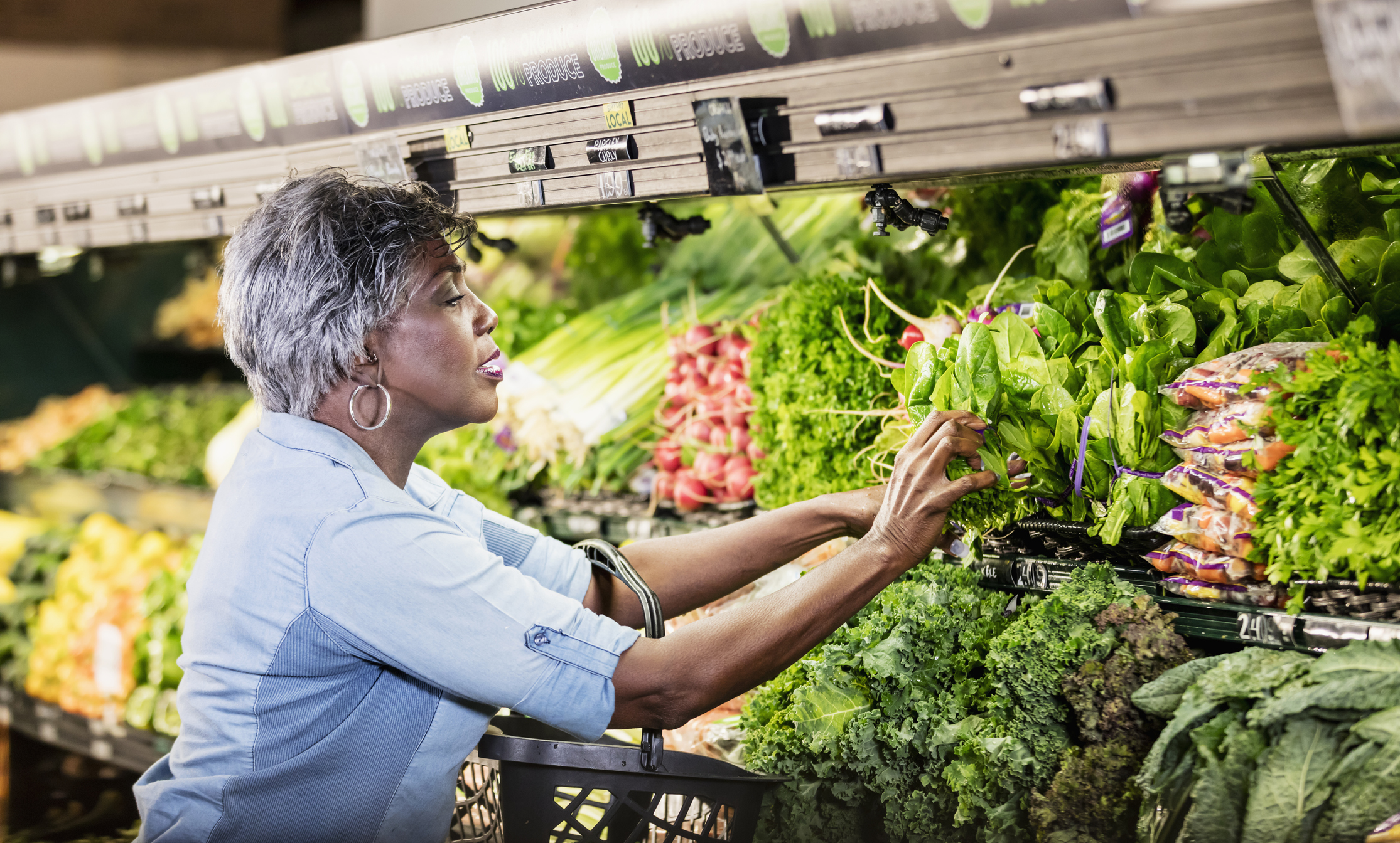 A person reaching for produce.