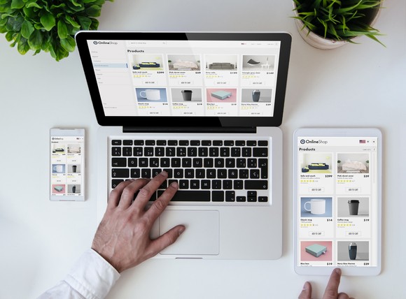 A computer, tablet, and smartphone displaying online storefronts.