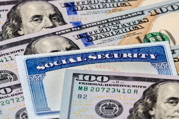 A Social Security card in between $100 bills.