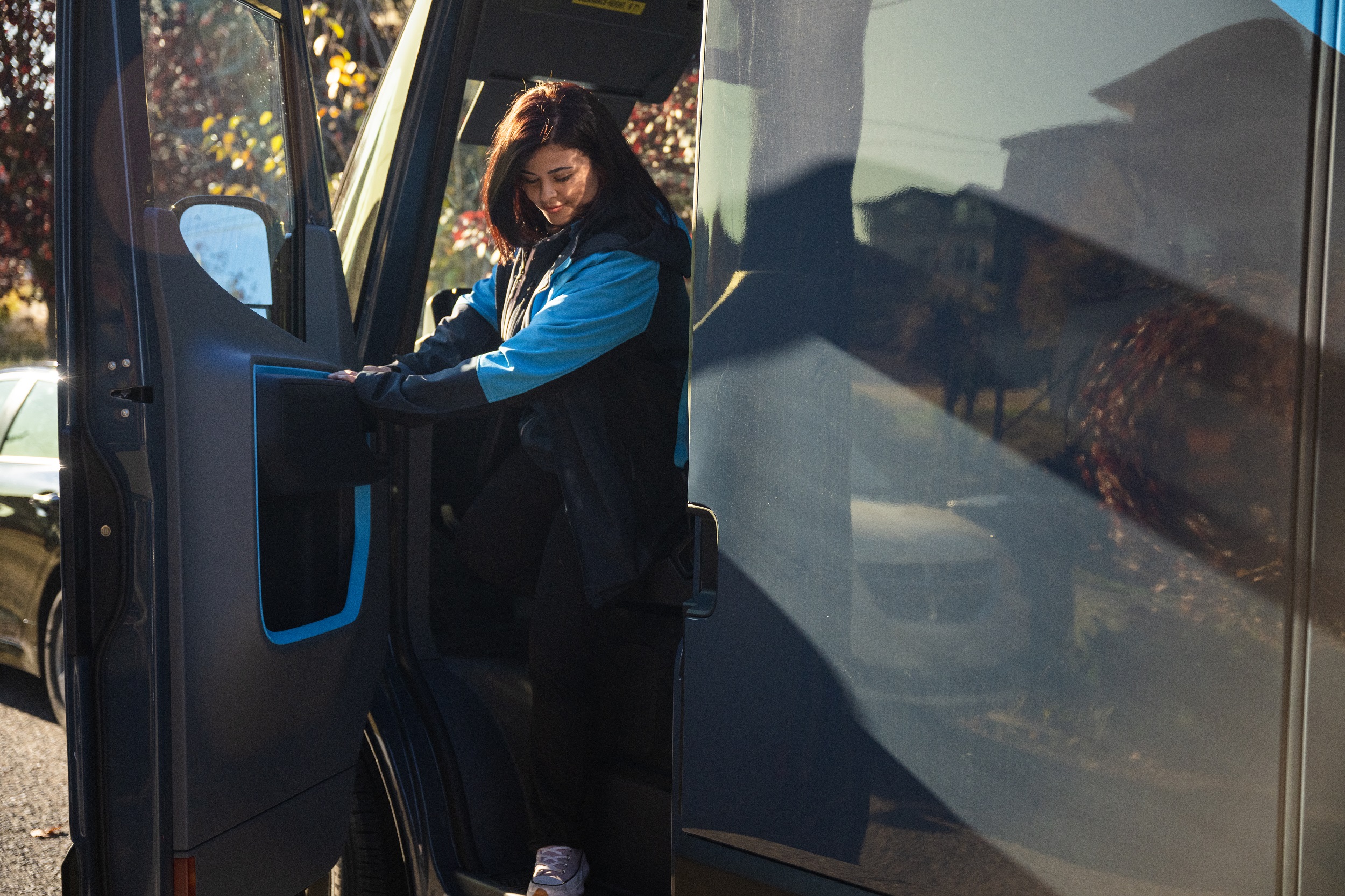 Amazon driver exiting a delivery truck.