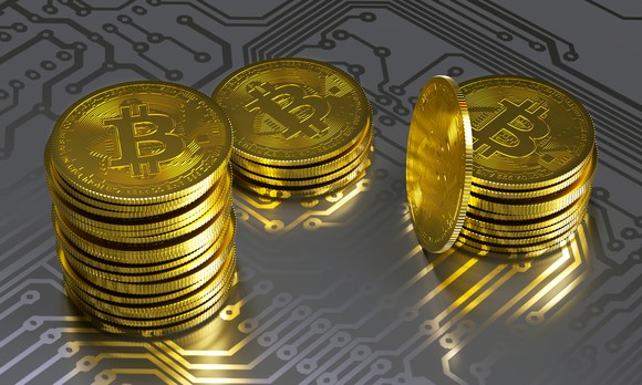 Bitcoin tokens on a circuit board.