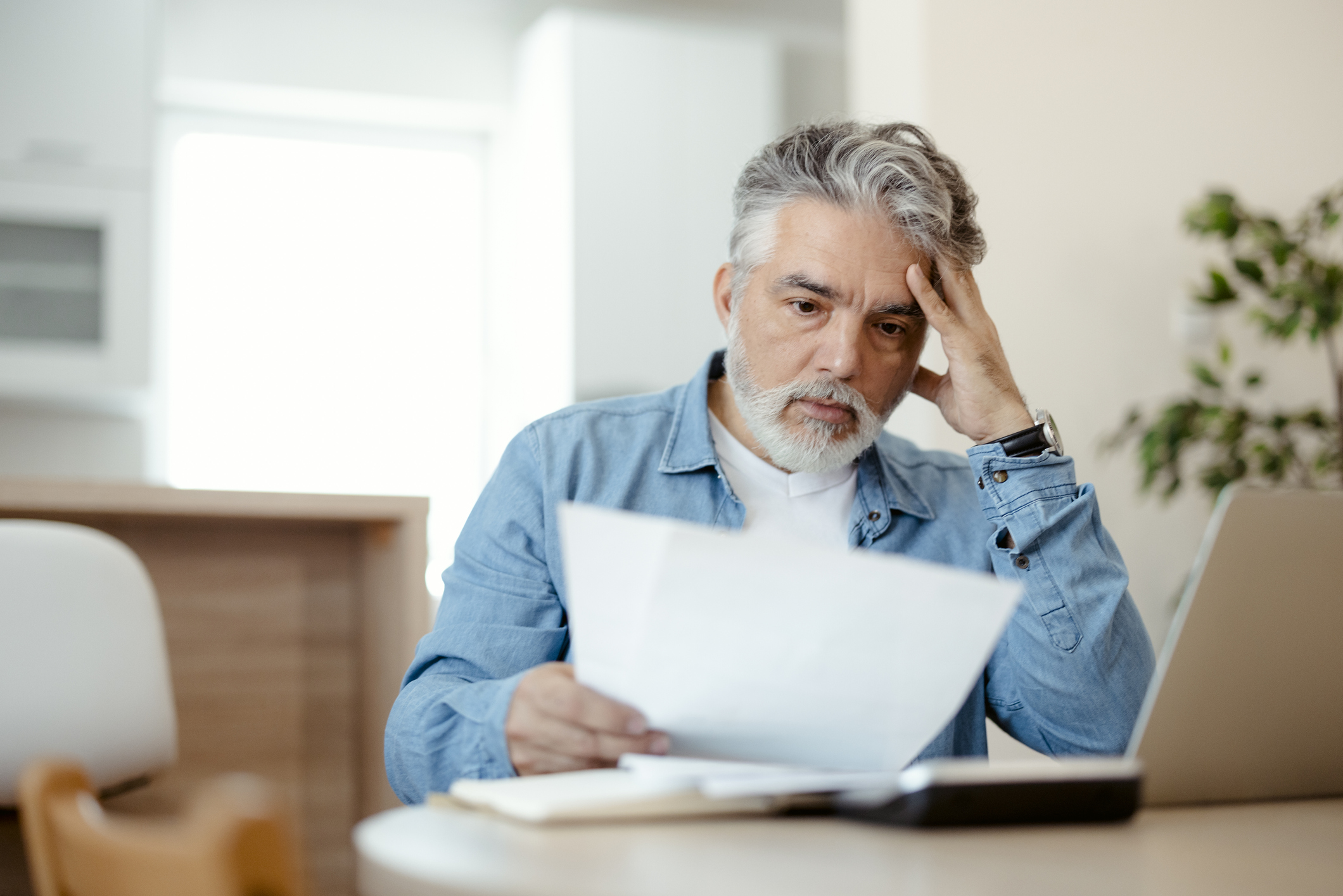 A person holding a document at a table.