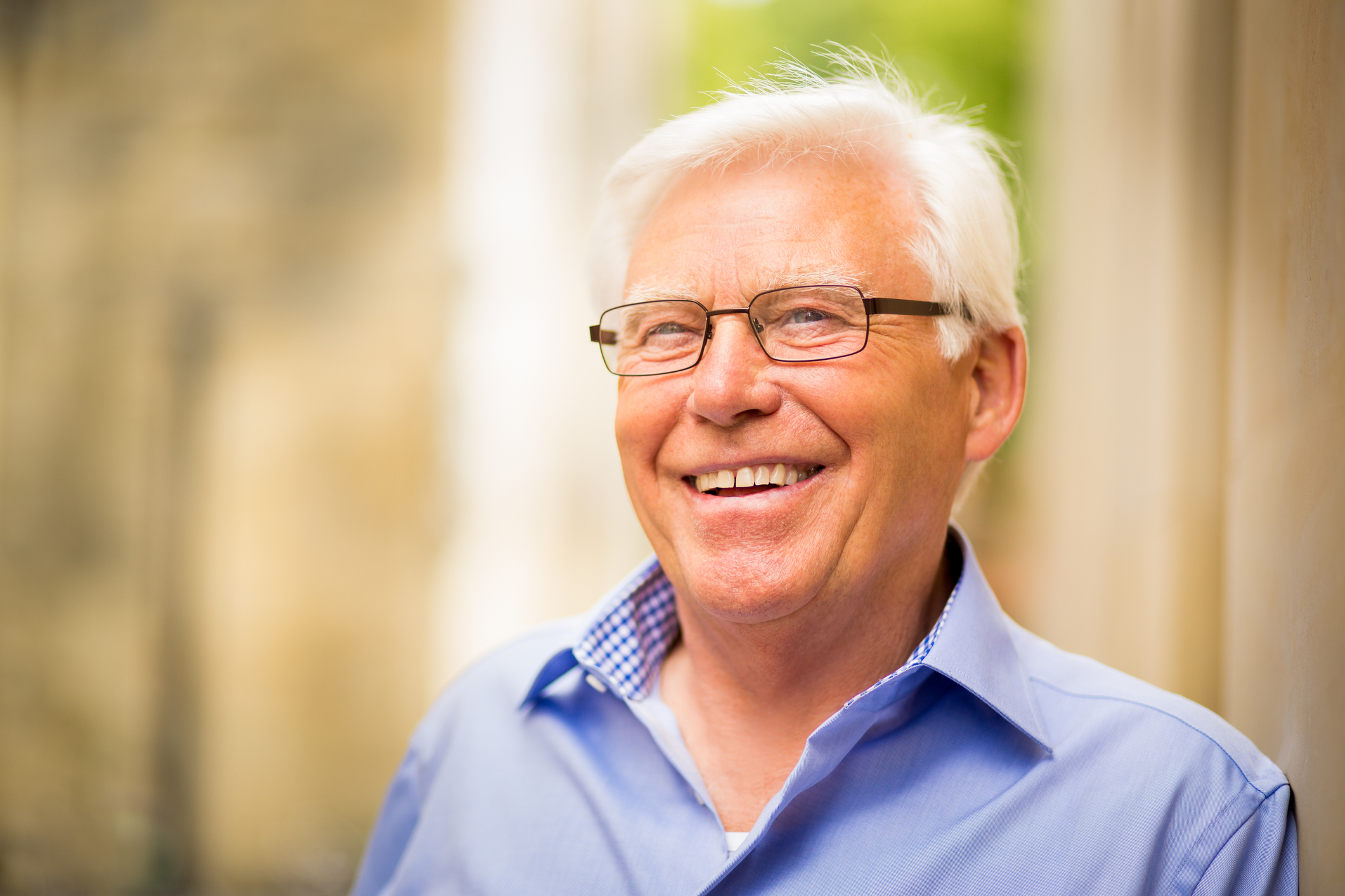 A person in a blue shirt is smiling. 
