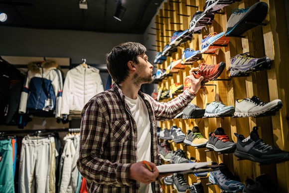 A man looking at shoes in a shoe store