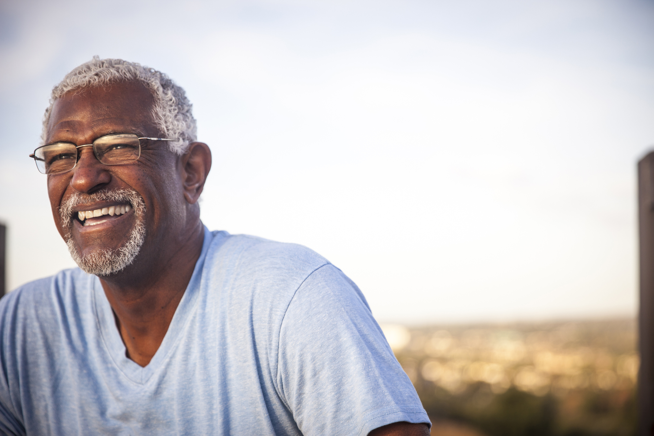 A smiling person outdoors.
