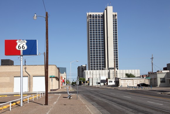 A commercial building on a road with little traffic.