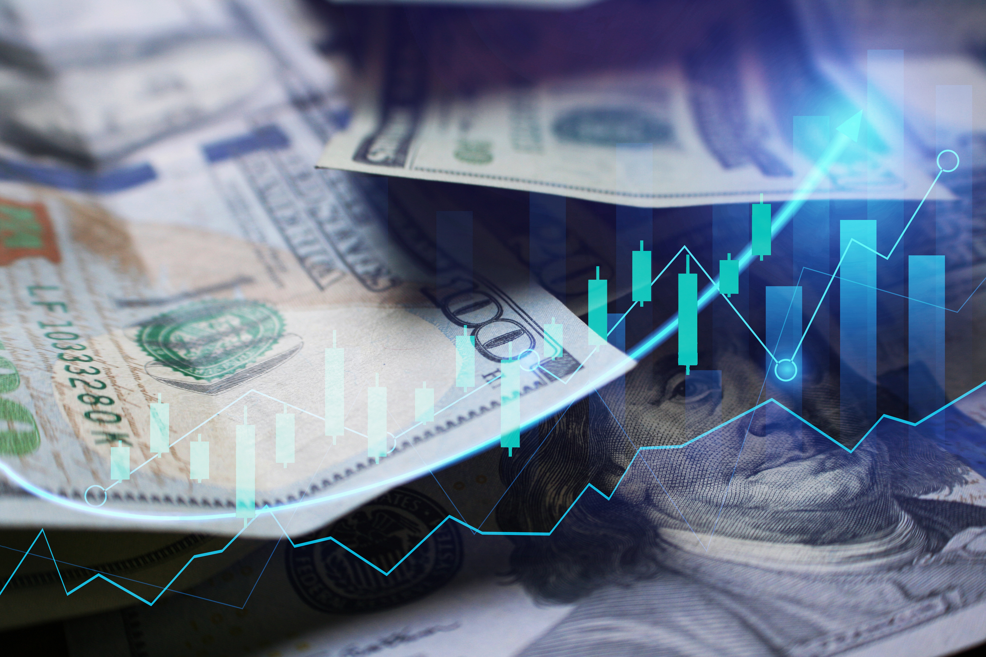 Stock chart in front of $100 bills.
