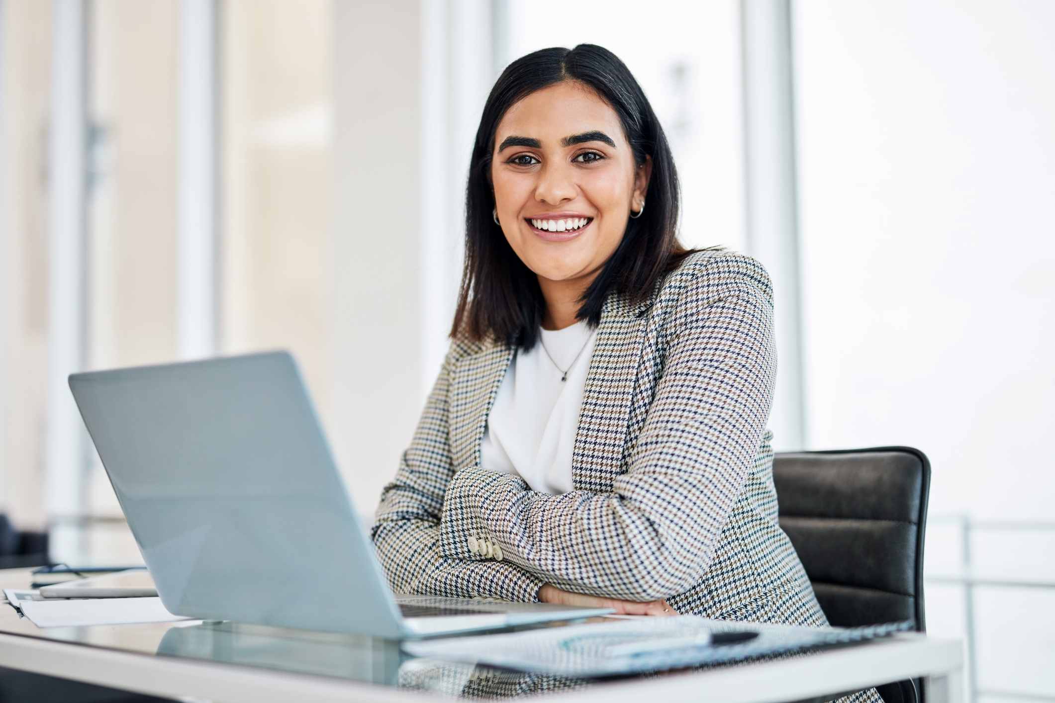 Woman 20s_A smiling person at a laptop_GettyImages-1354842602