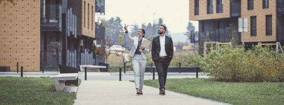 Two people walk through a commercial real estate property.