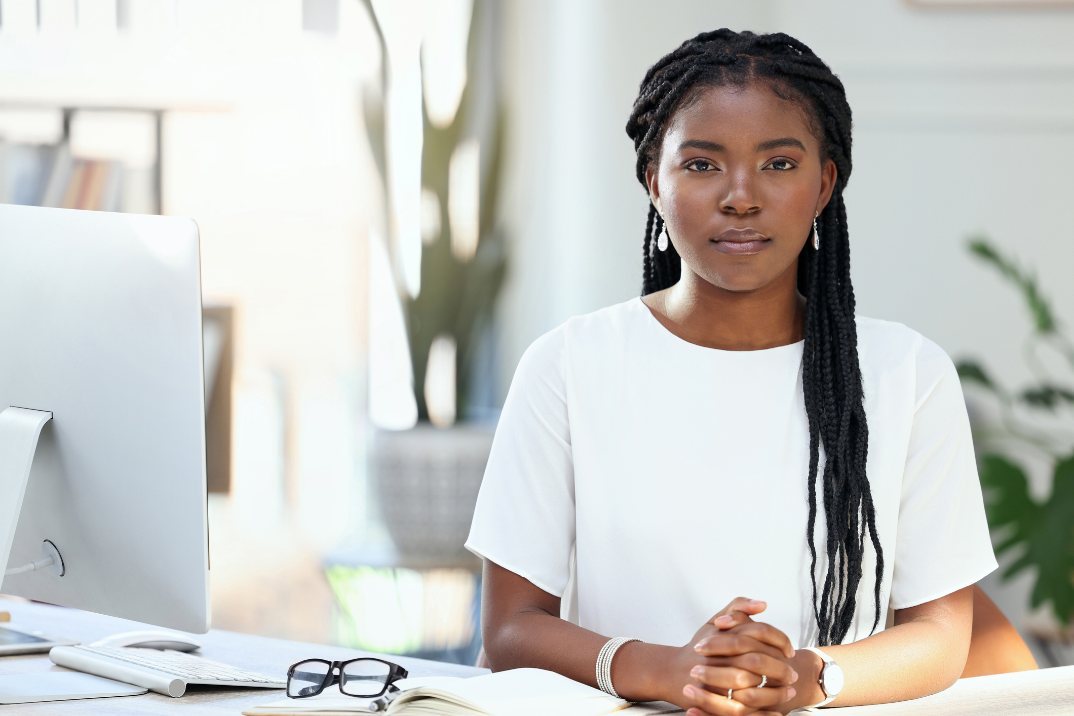 A serious person at a desk.