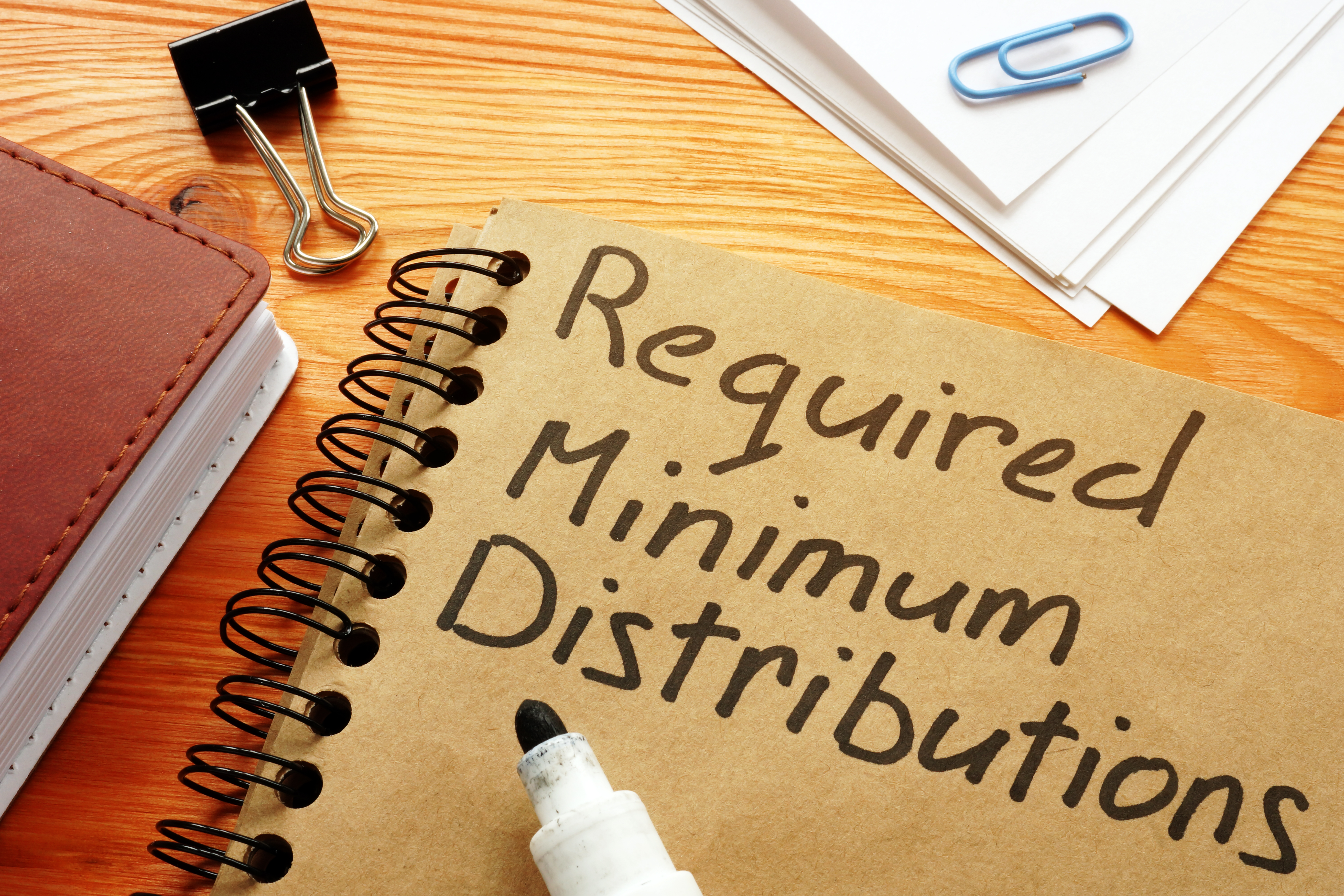notebook with required minimum distributions written on it.