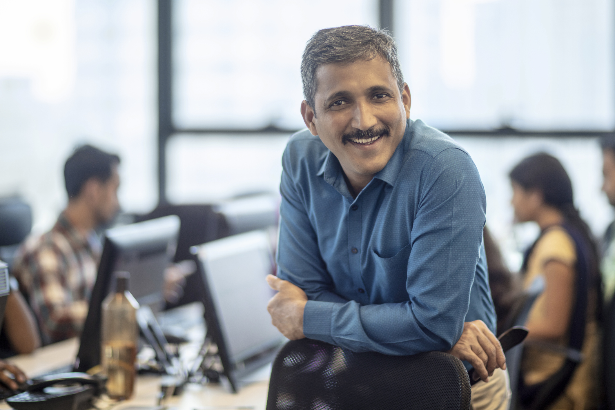 Someone at an office, smiling at the camera.