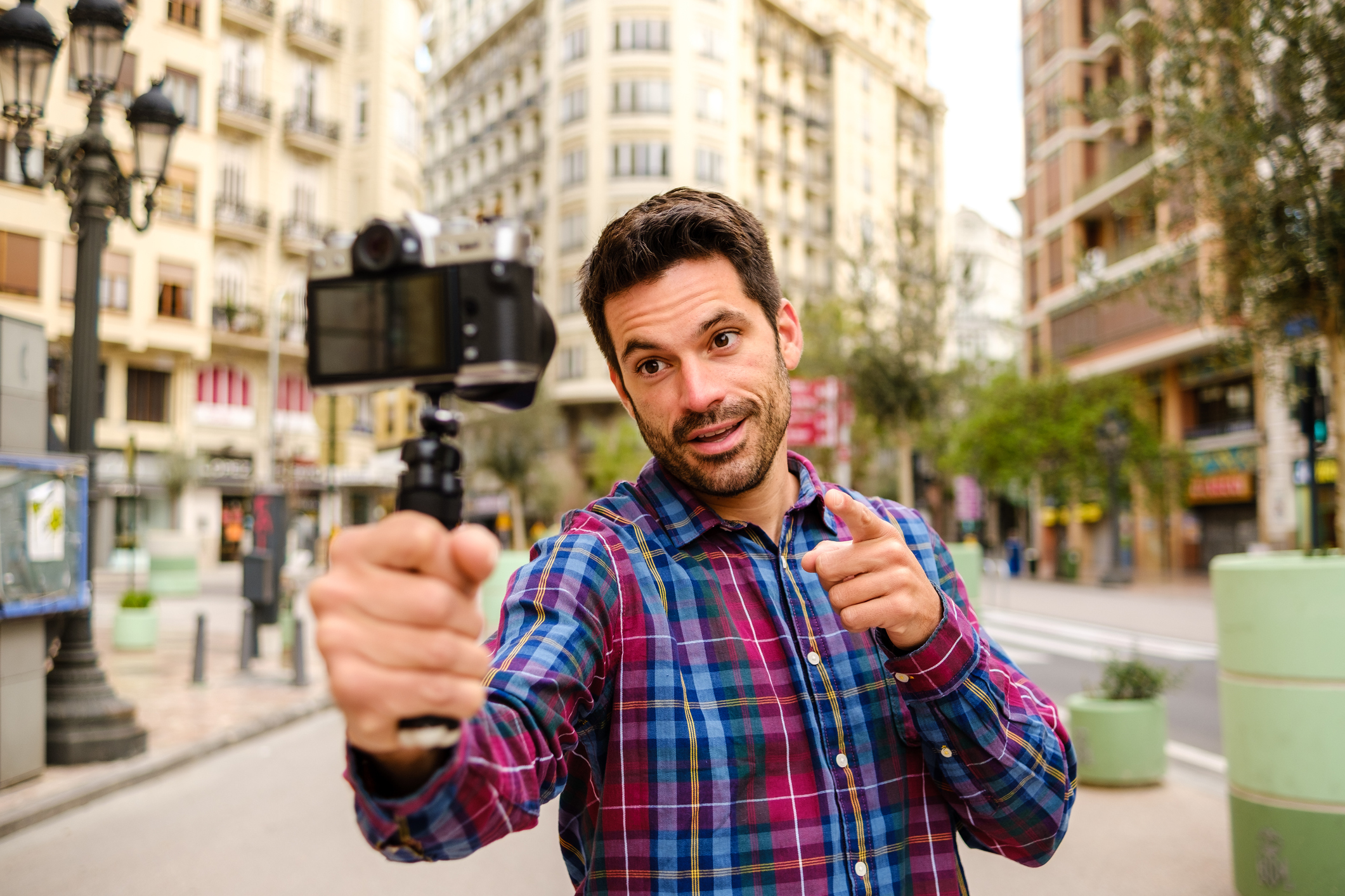 A person taking a selfie and posting on social media
