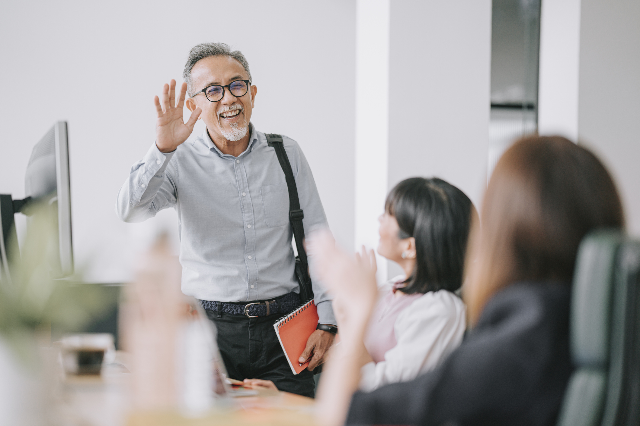 Just retired person waves goodbye to colleagues