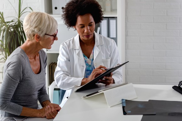 A doctor showing a patient lab results.
