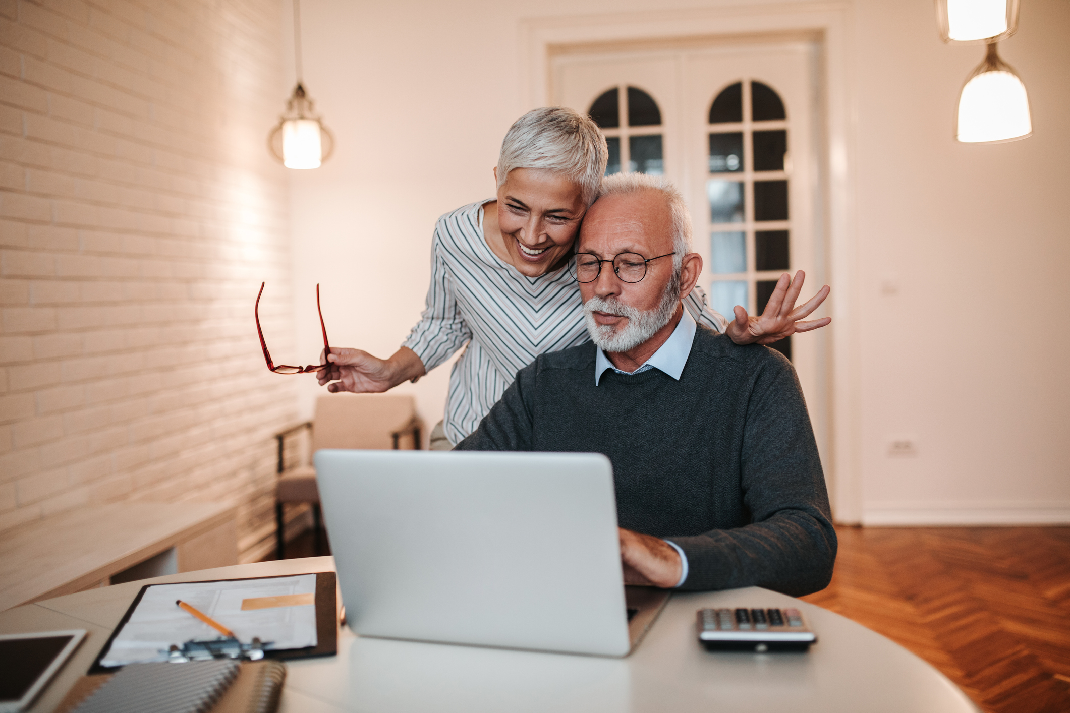 Two people looking at laptop.