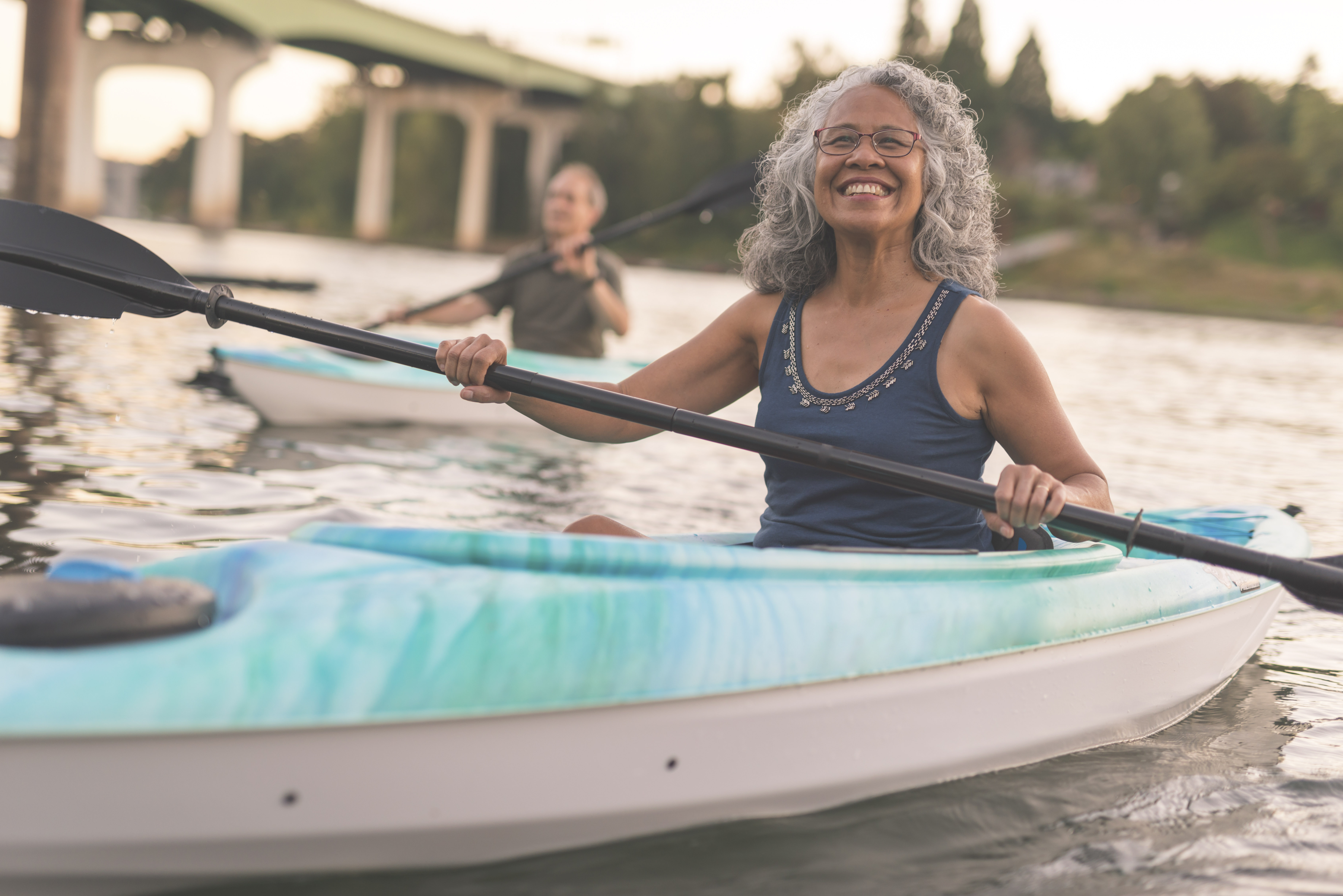 Two people kayaking in a body of water.