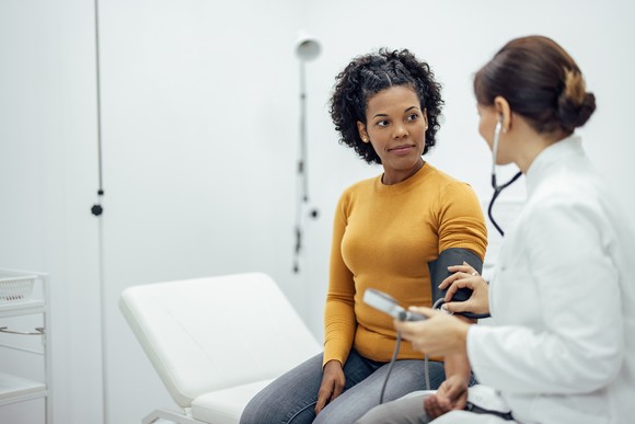 A patient at their checkup with a doctor.