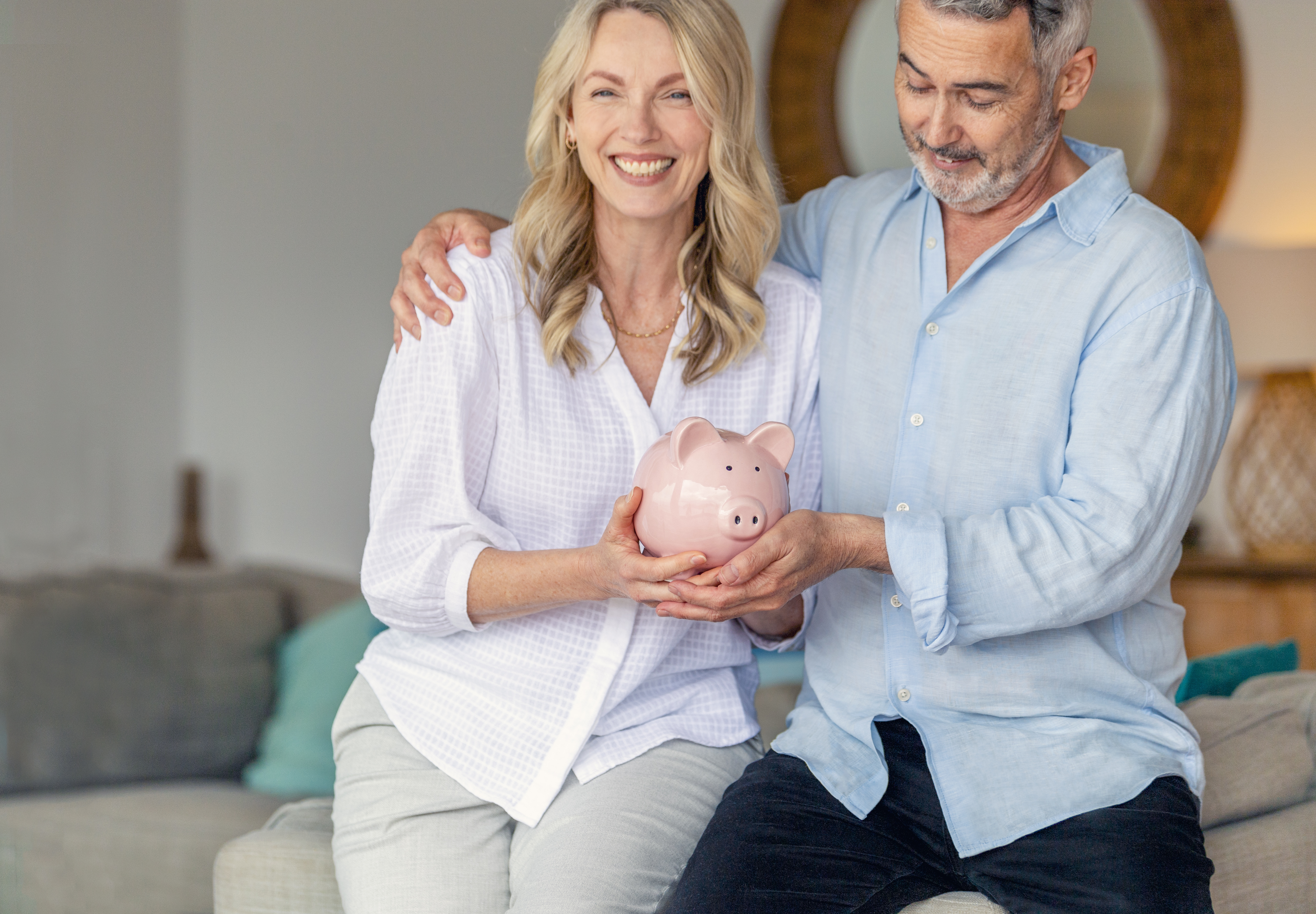 Two people holding a piggy bank.