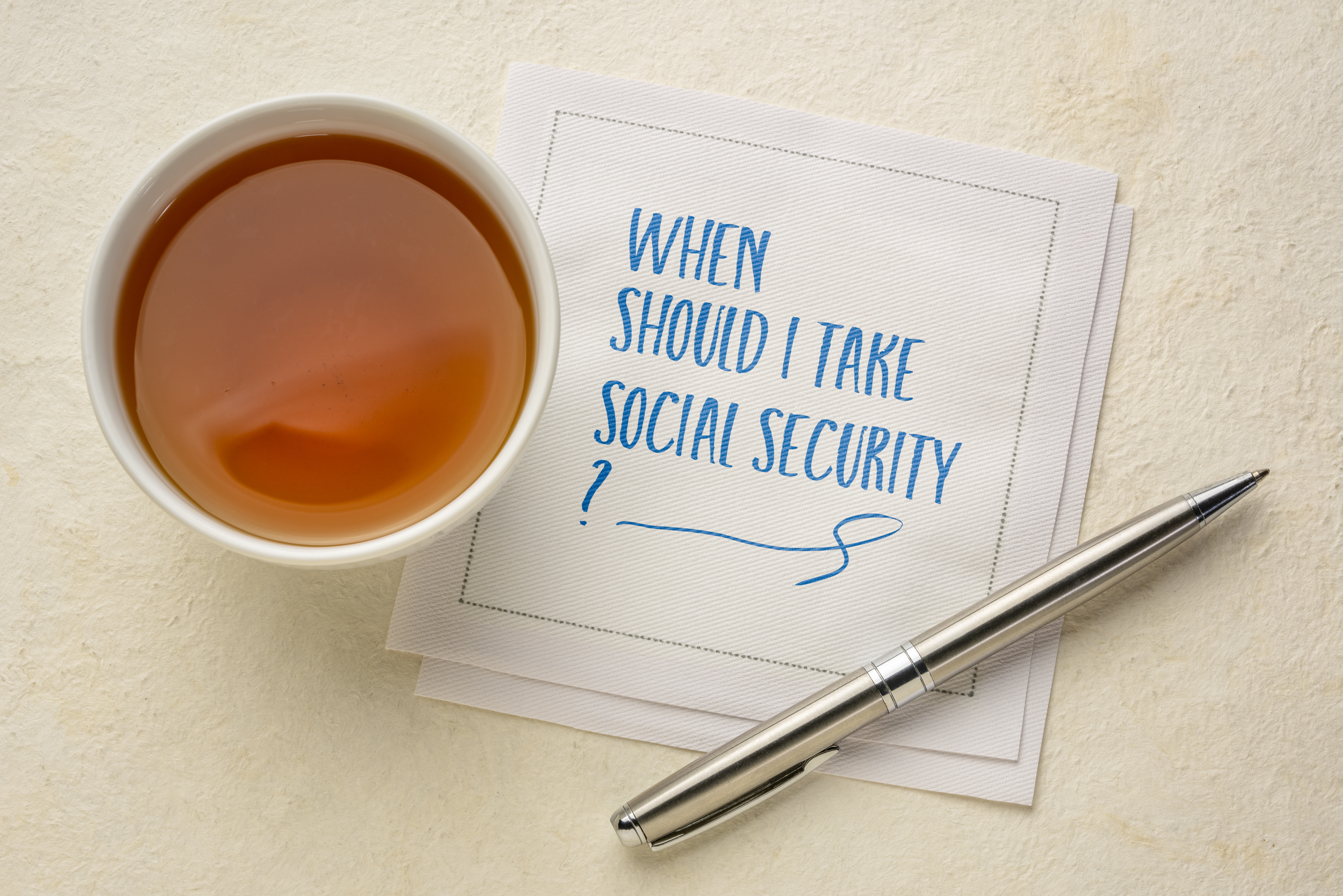 Napkin with "When Should I Take Social Security?" written on it.