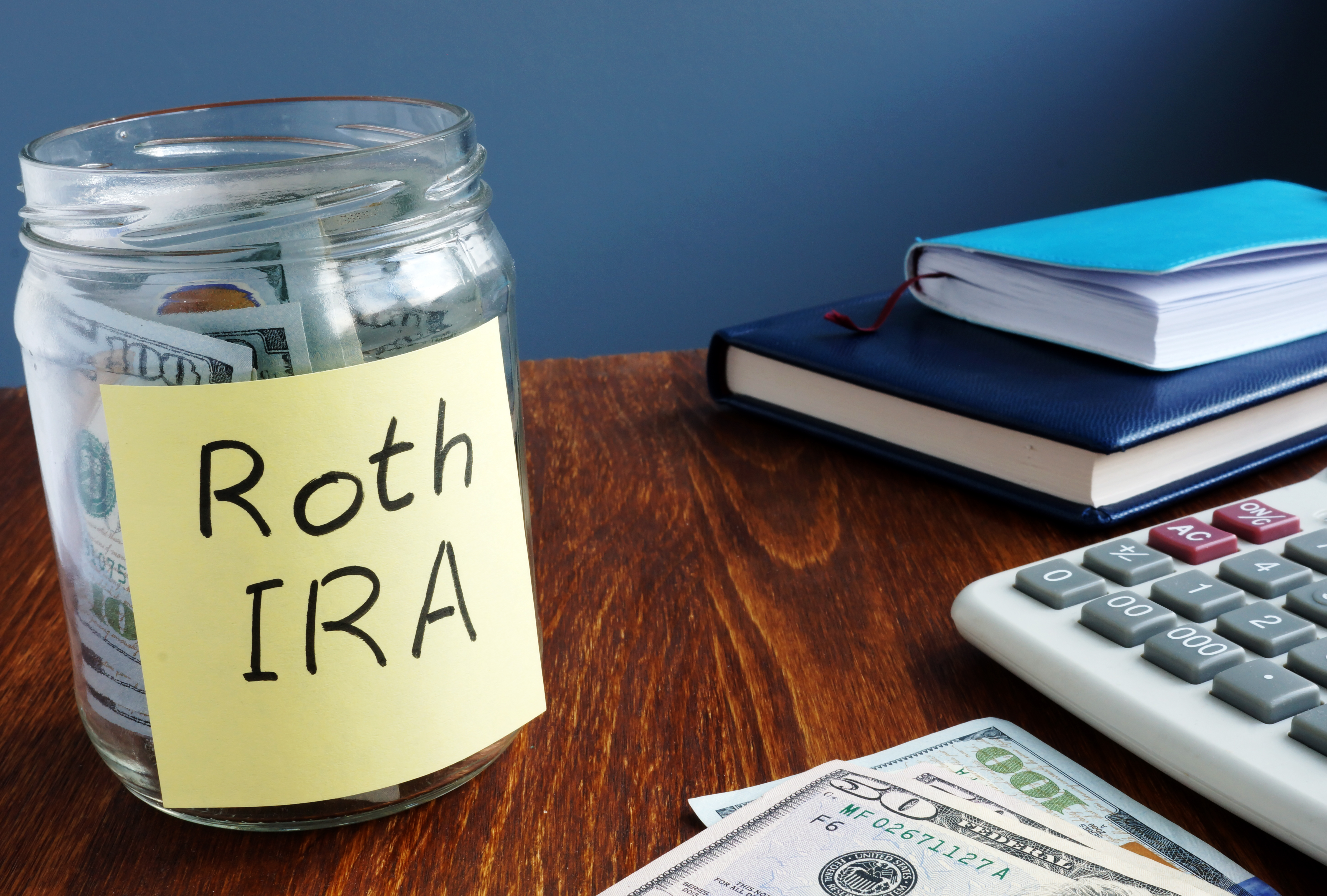 Jar with Roth IRA written on it and money inside it.