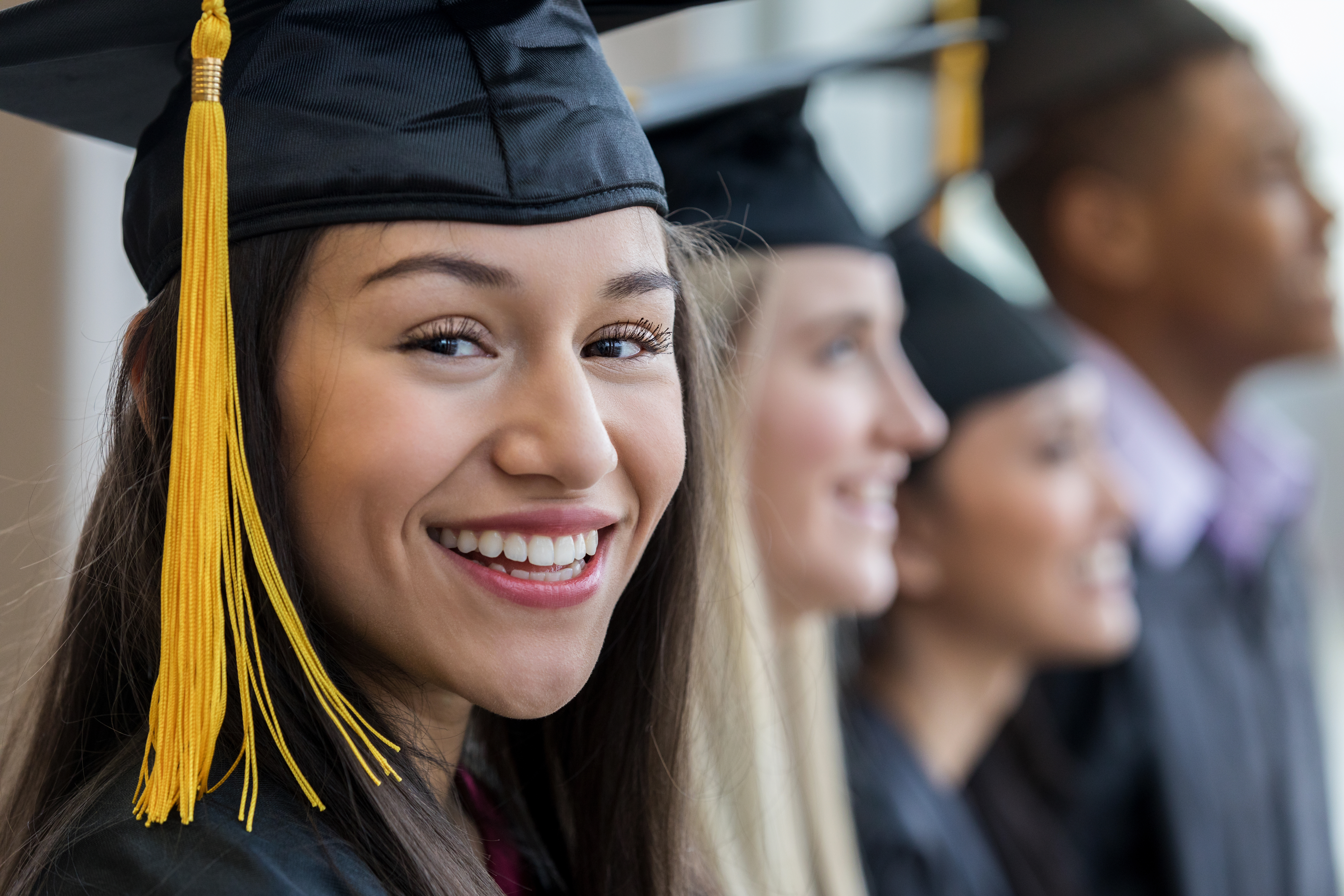 Students in caps and gowns at a graduation ceremony.