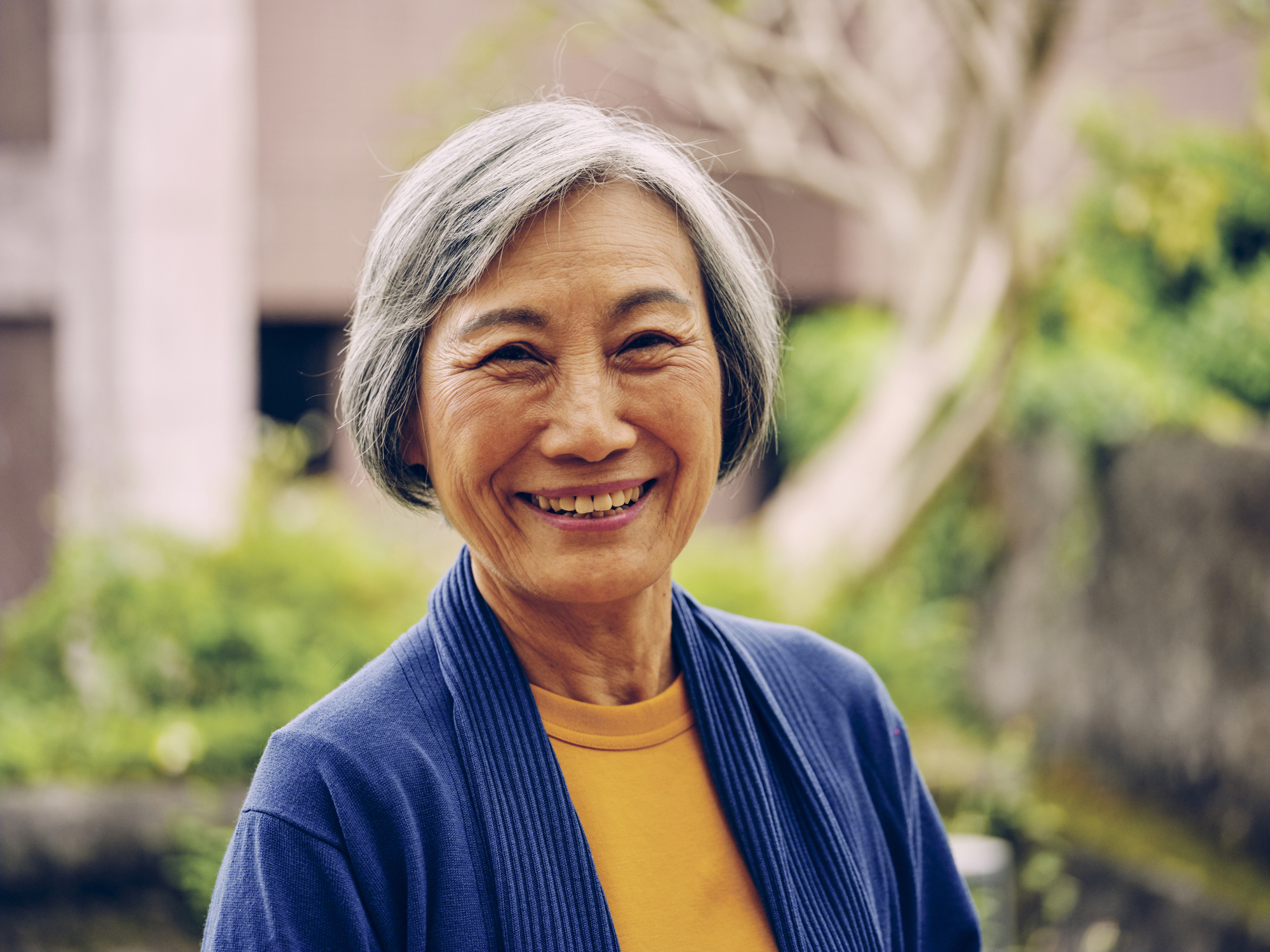 A person outdoors, smiling.