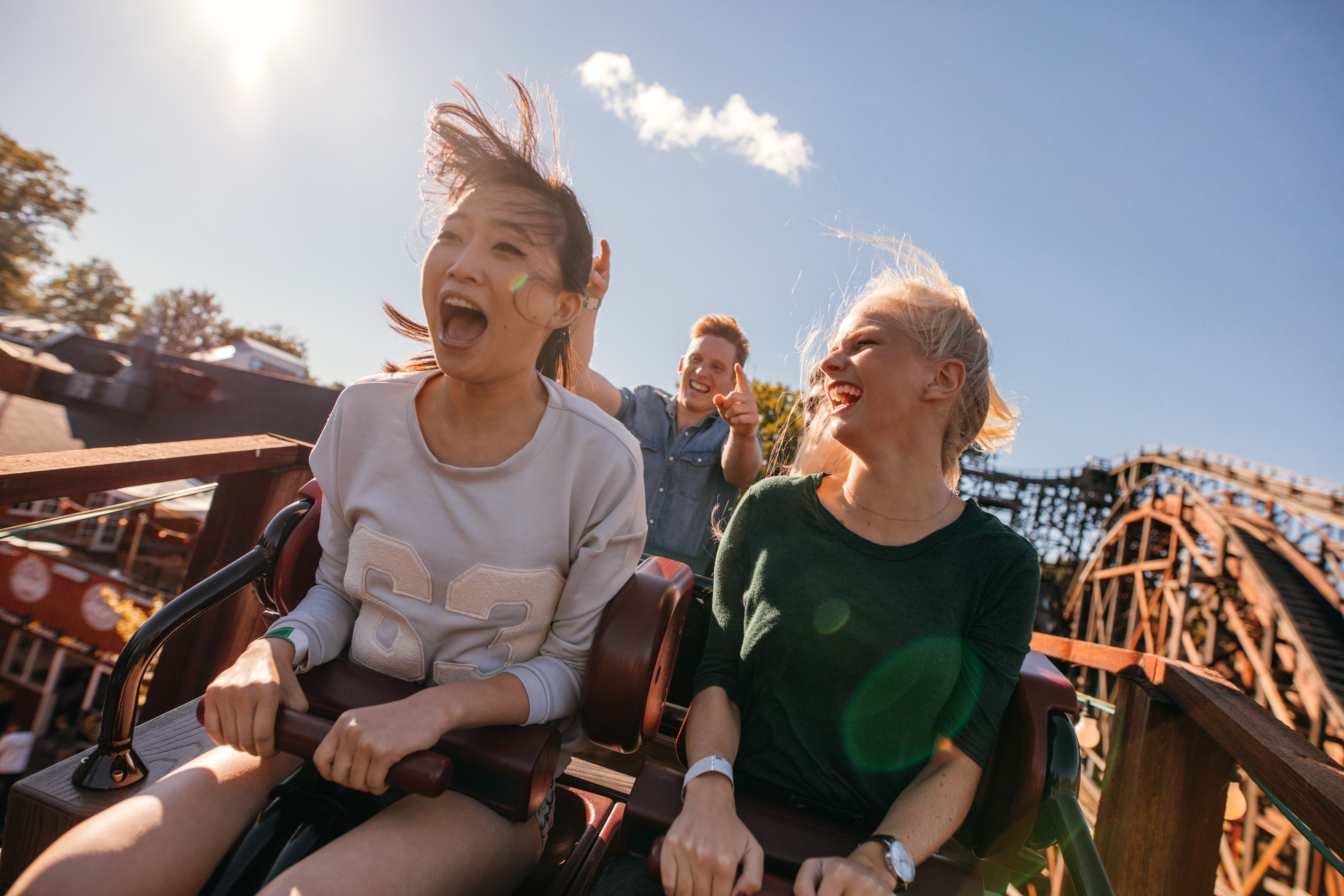 People riding a roller coaster in an amusement park