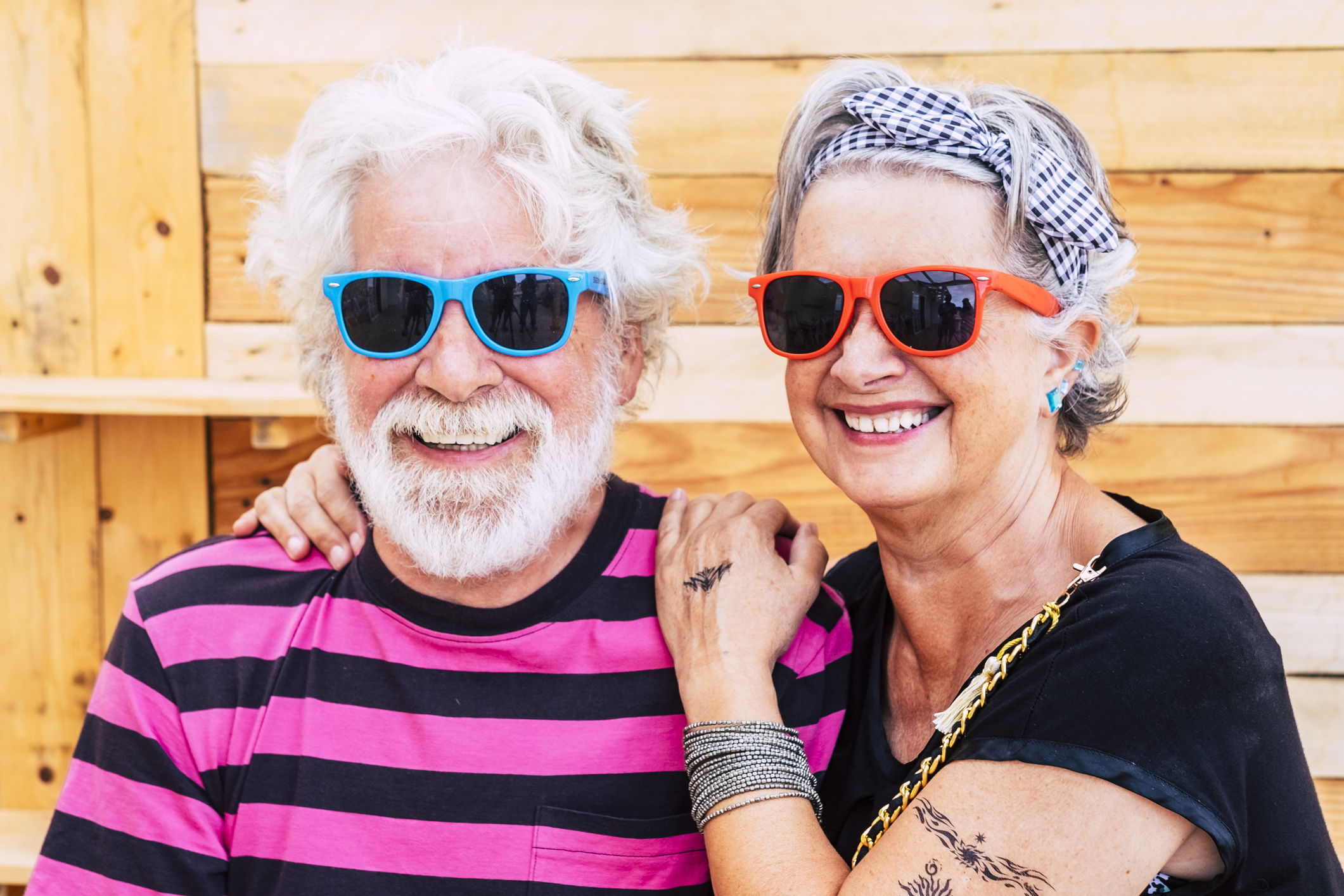 Two smiling people in sunglasses.