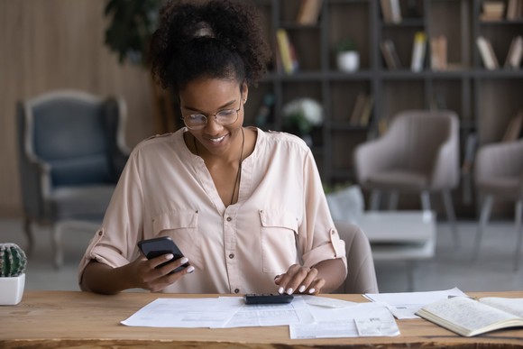 Person sitting at a desk looking at paperwork.