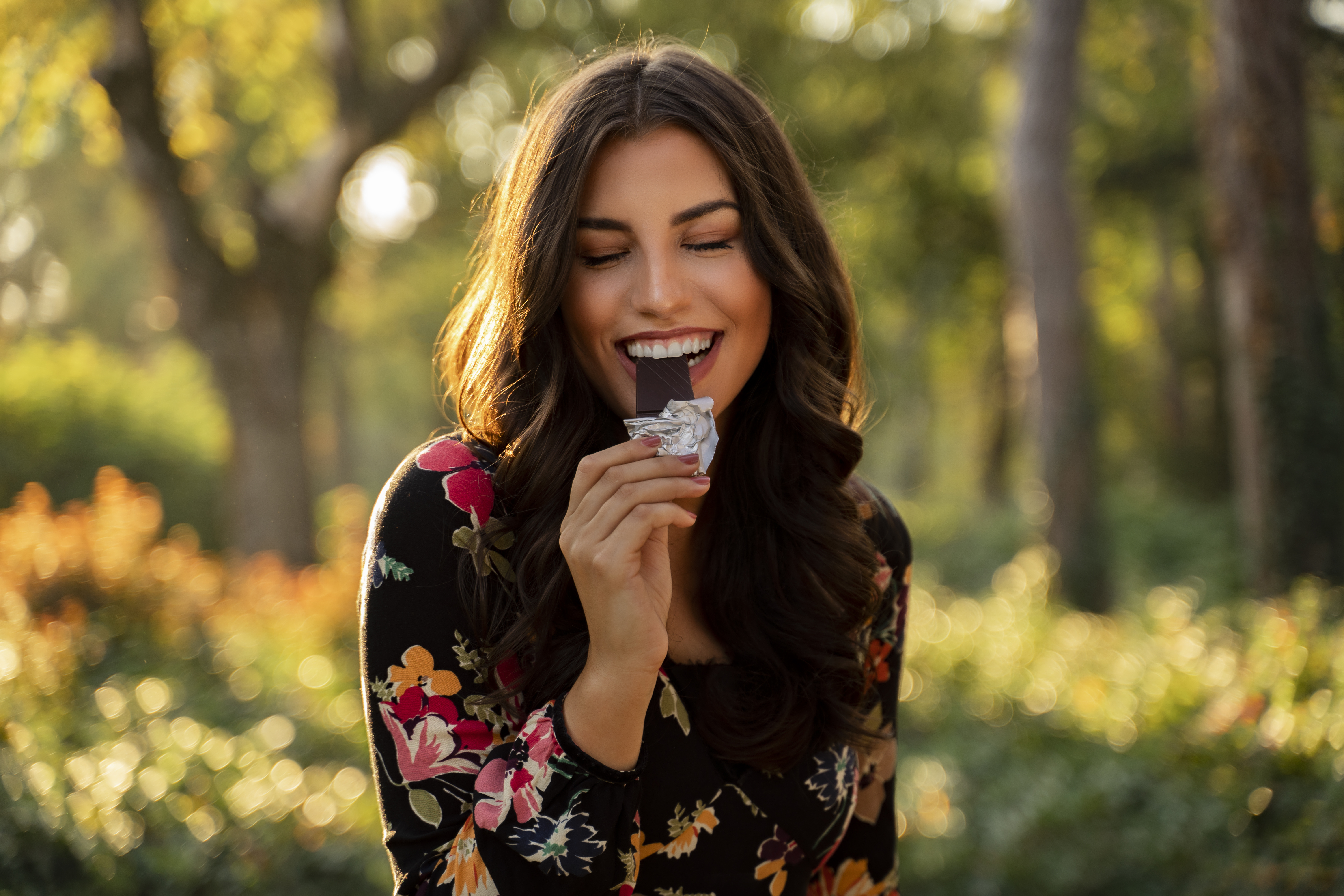 A person eating a chocolate bar.