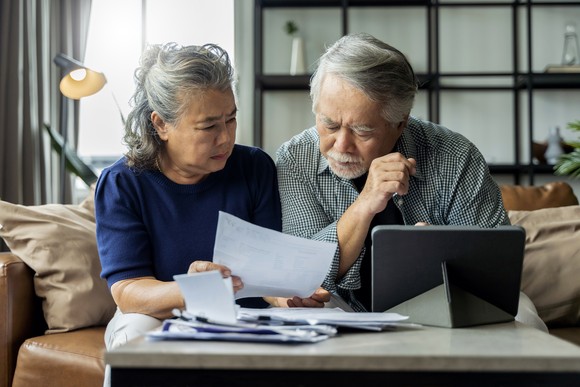 Couple looking at a document together in their living room.