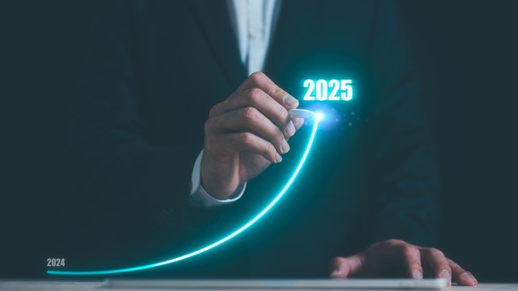 An investor's hand traces a line upward to 2025.