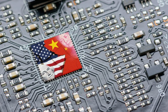 A microprocessor overlaid with images of the American and Chinese flags.
