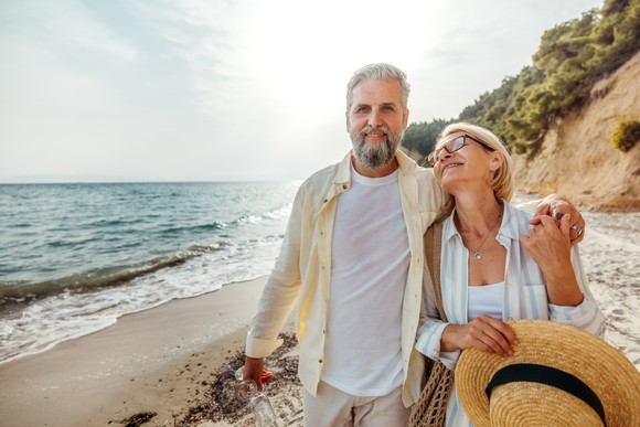 A couple walking along the beach. 