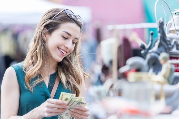 Someone smiling and counting bills.