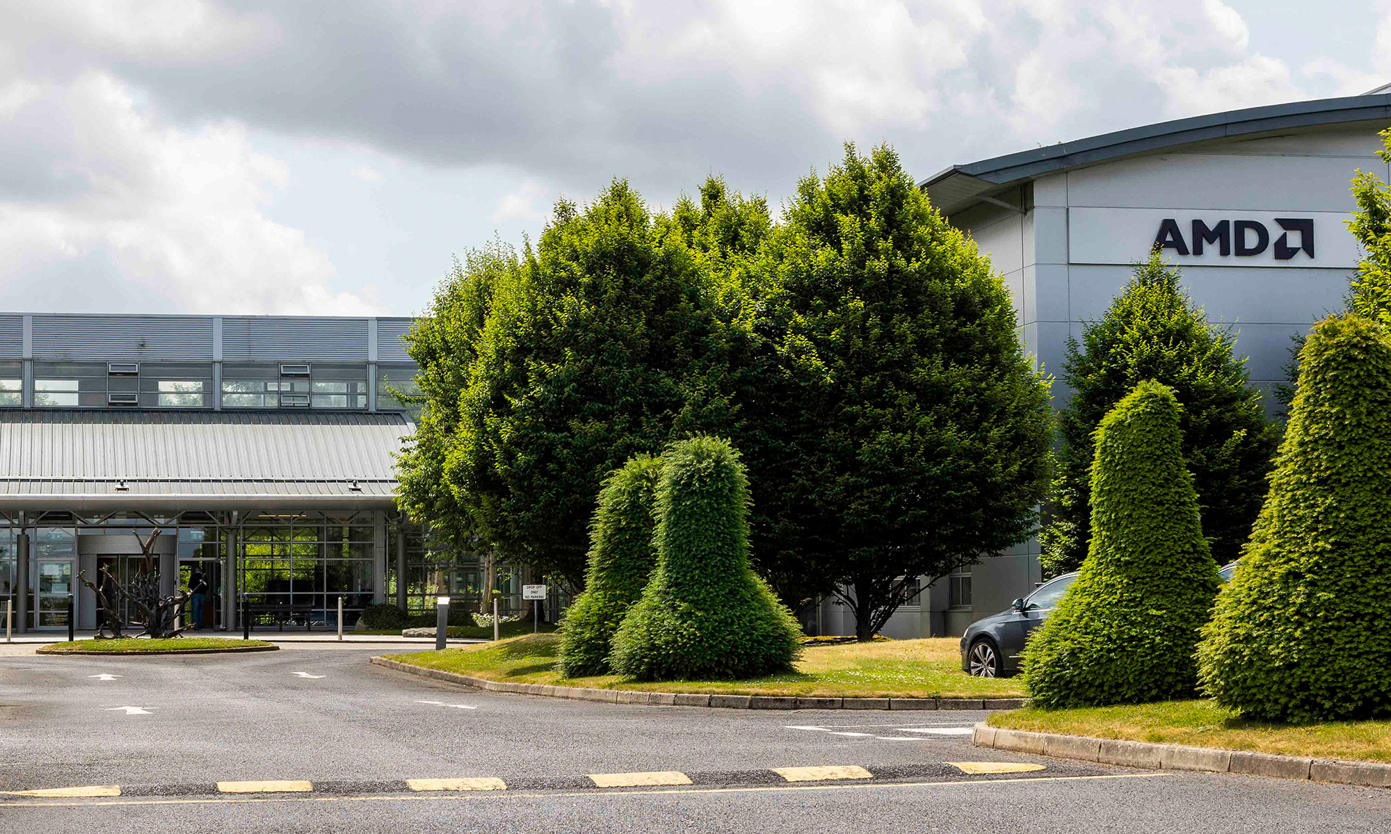 AMD Ireland headquarters with sign with AMD logo on outside.