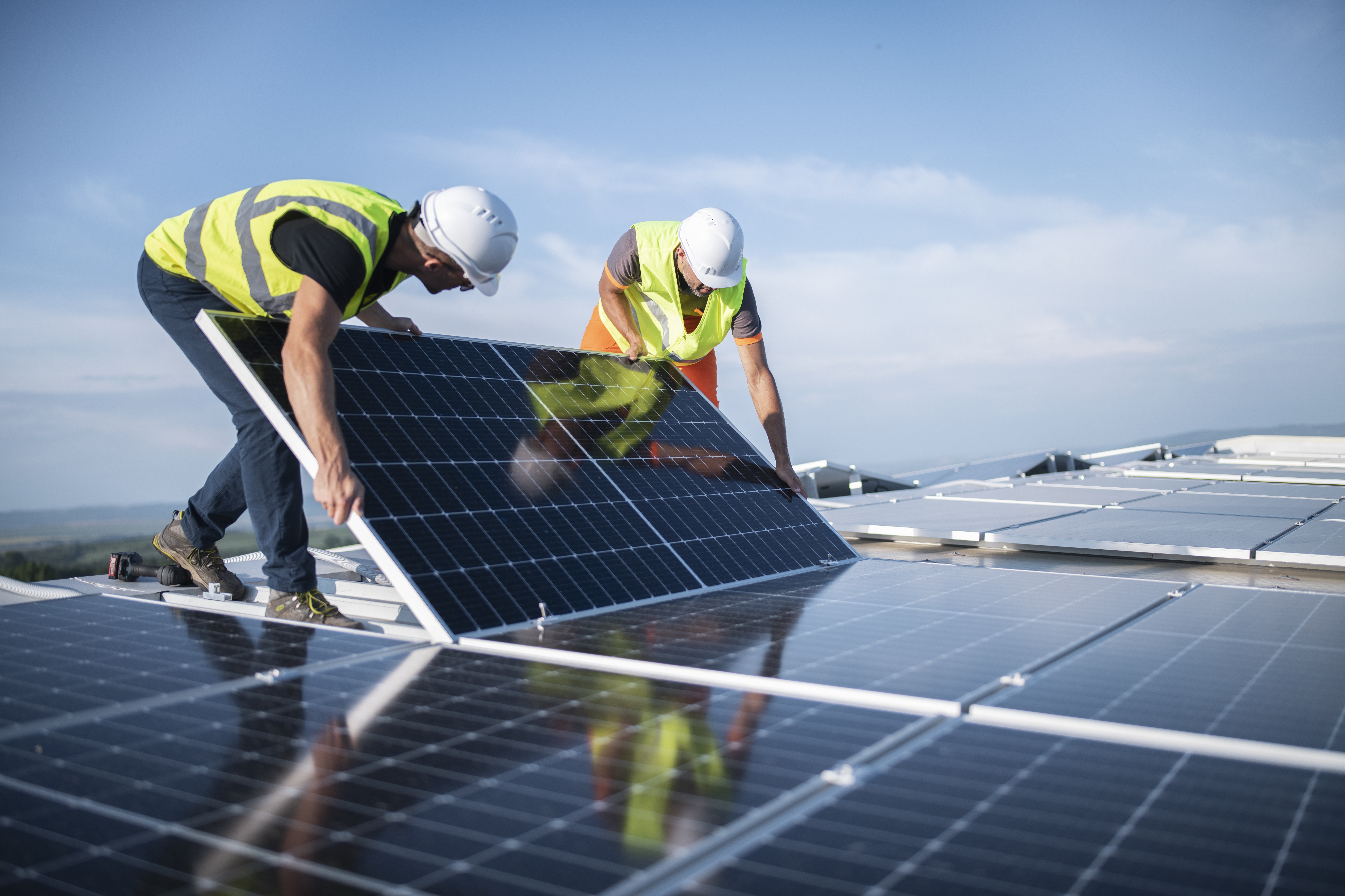 Two technicians installing solar panels 1405880267