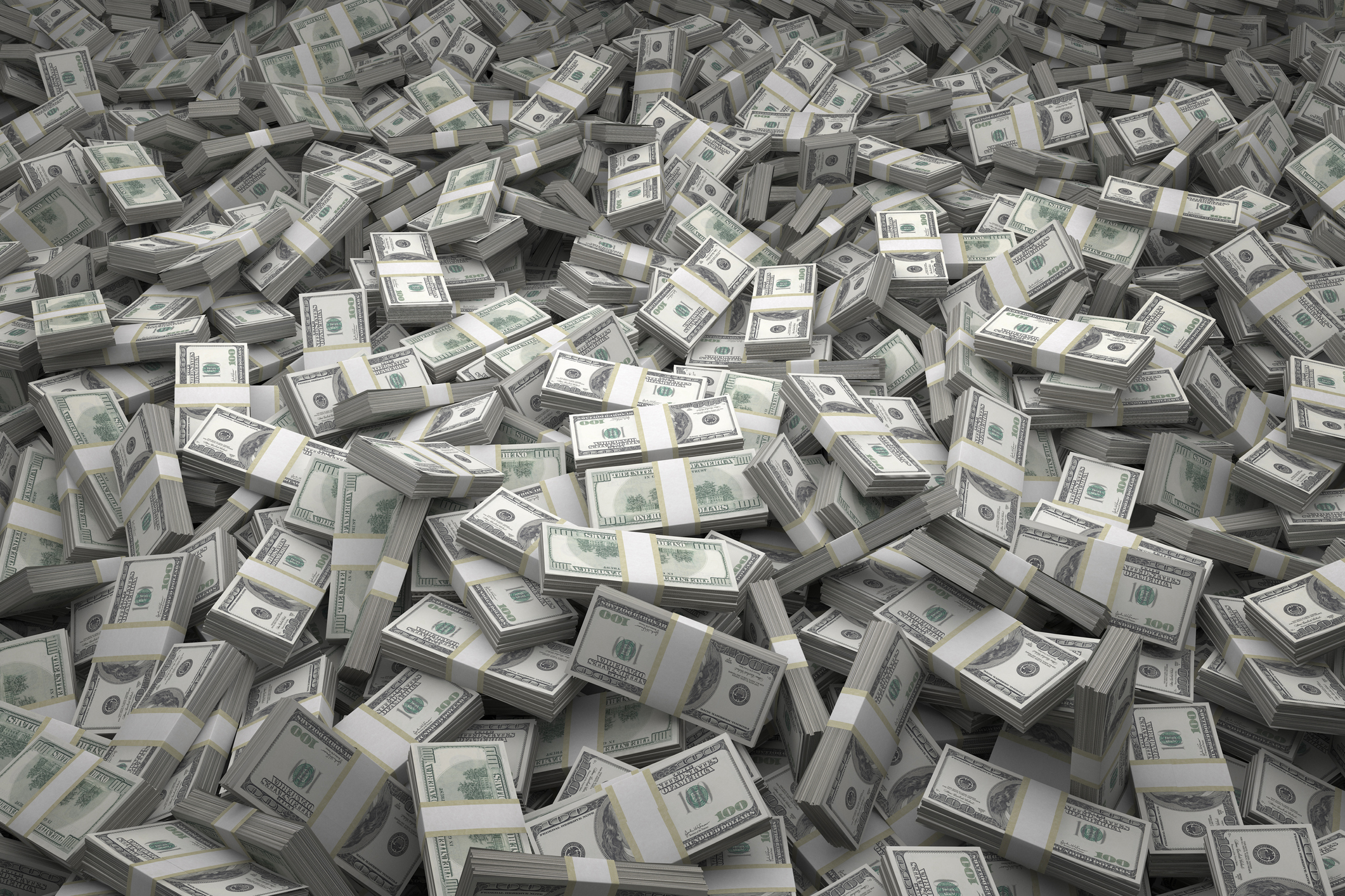 A huge pile of cash in bundles of $100 bills.