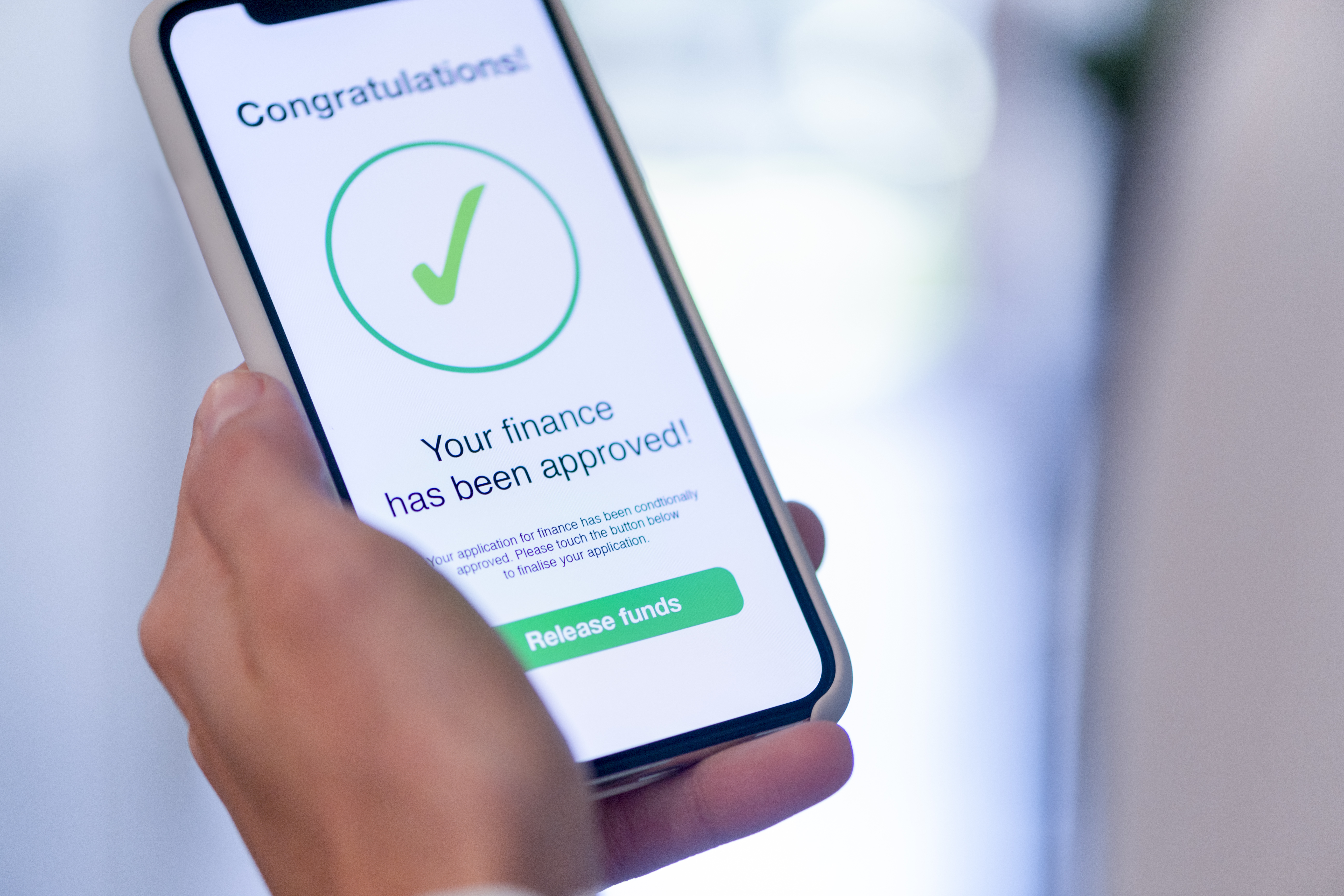 Person receiving loan approval on their mobile banking app.