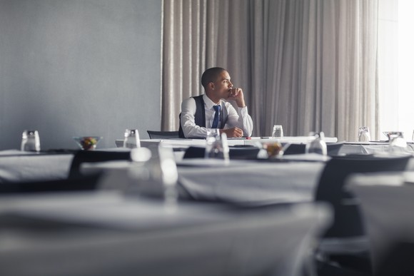 A person sitting a table thinking.