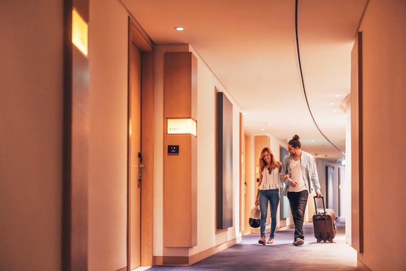 Couple walking down the hallway in a hotel.