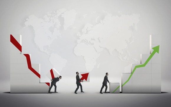 People moving blocks from a down red arrow towards those with a green up arrow.