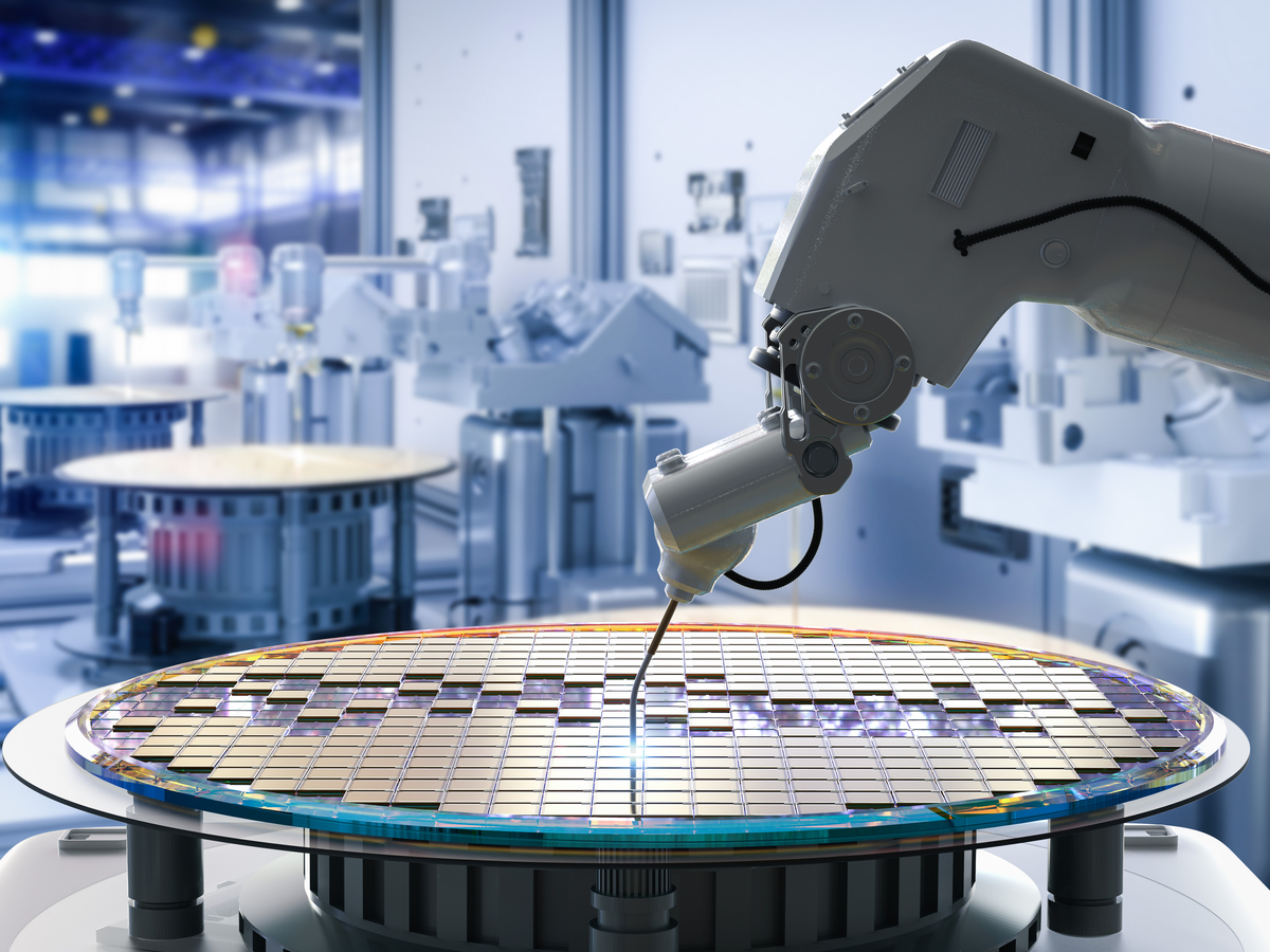 A robot arm fabricates a computer chip.